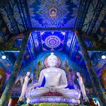 Admire the ornate details of Wat Rong Suea Ten ("Blue Temple") in Chiang Rai