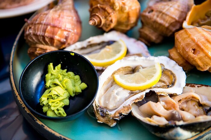 Sample gourmet Japanese foods, such as Takehara's oysters at Suzuki Farm on a art and culture tour of Eastern Setouchi