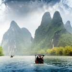 Experience the dramatic karst scenery in Guilin during a boat ride down the tranquil Li River