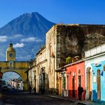 See Agua volcano looming behind iconic Santa Catalina Arch, a landmark in Spanish colonial Antigua & UNESCO World Heritage Site