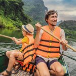 Paddle past limestone mountains in Ninh Binh with your family