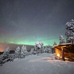 Cabin in the snow with Northern Lights