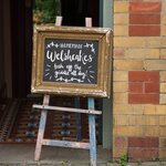 A sign advertising Welsh cakes, which you'll taste on a gourmet tour of Cardiff
