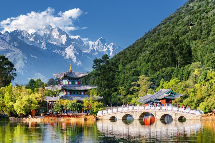See the snow-covered mountains reflected in the Black Dragon Pool near Lijiang