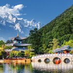 See the snow-covered mountains reflected in the Black Dragon Pool near Lijiang