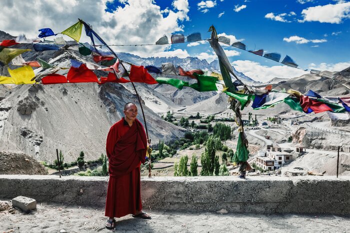 A Buddhist monk stands outside Lamayuru Temple