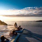 Watch the midnight sun from a seaside soaking tub in Senja (photo courtesy of Hamn i Senja)