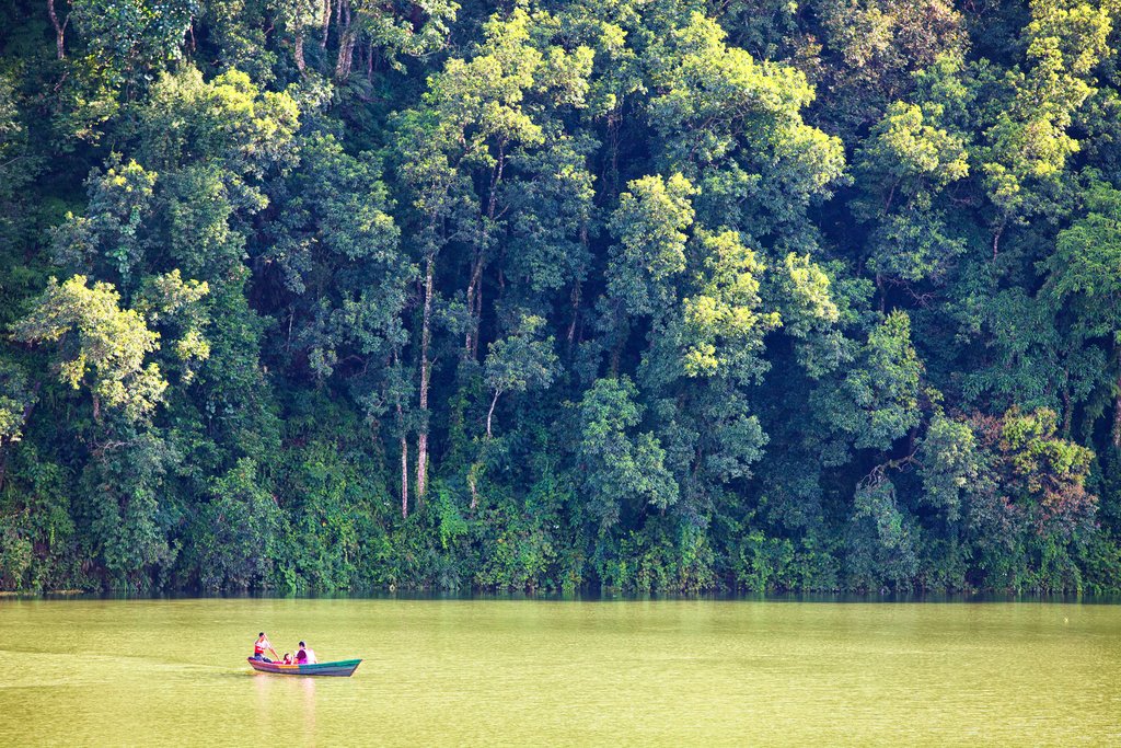 A small wooden boat on tour around Phewa Lake