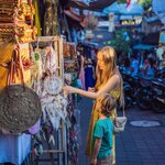 Mother and son shop for souvenirs in an Ubud market