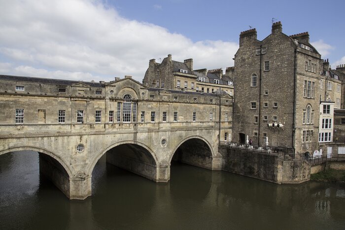 A stone bridge across the River Avon in Bath