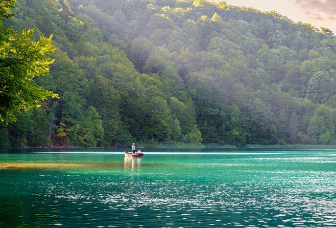 Explore watery landscapes of Plitvice Lakes National Park with a tranquil boat ride