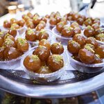 Sample classic Greek treats like loukoumades (honey doughnuts)