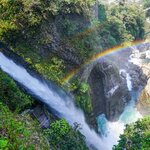 A rainbow over the Pailón del Diablo waterfall in Baños