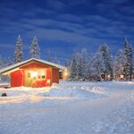 Cabins glow at night in Kiruna along the Star Trail of Swedish Lapland