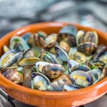 Sample local favorites like Portuguese-style clams on this gastronomic adventure across the Iberian Peninsula