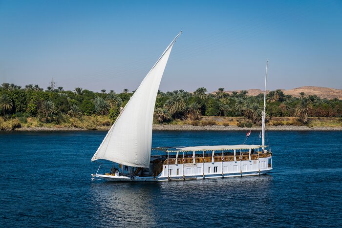Spend four days sailing along the Nile River aboard a dahabiya (traditional sailboat)
