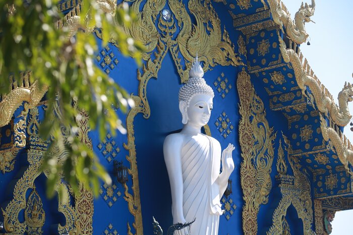 Admire the ornate details of Wat Rong Suea Ten, otherwise called the "Blue Temple," in Chiang Rai