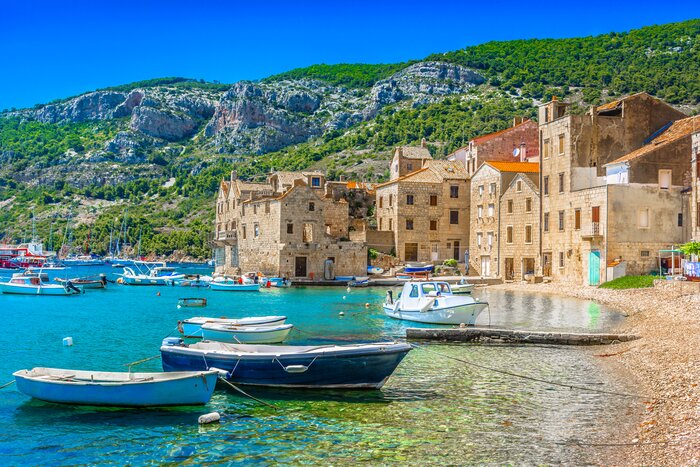 An idyllic summer scene of Komiza's harbor on the island of Vis