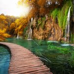 Follow wooden paths and dirt trails through the lakes and waterfalls of Plitvice Lakes National Park