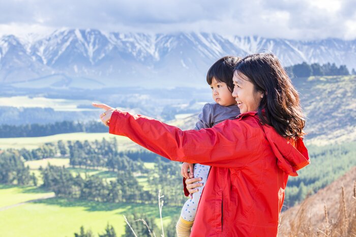 Mother and child looking at mountains in New Zealand