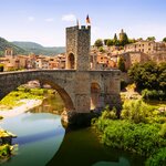 Enjoy a day trip to Besalú and see it's Romanesque bridge over the Fluvià River