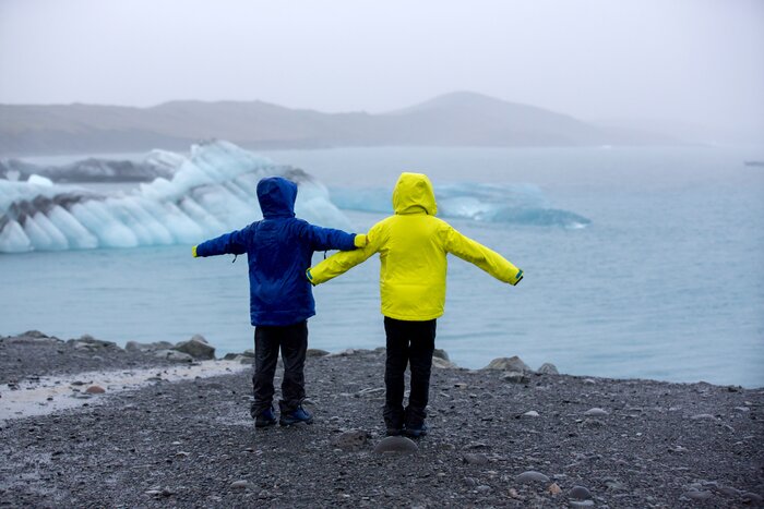 Siblings look out over Jökulsárlón glacial lagoon