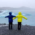 Siblings look out over Jökulsárlón glacial lagoon