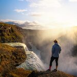 A hiker stands at Gullfoss