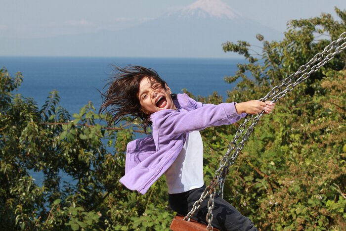 Swinging in the shadow of the Osorno volcano in Chile's Lake District