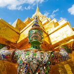 See colorful gold warrior statues at the Temple of the Buddha, Grand Palace, Bangkok