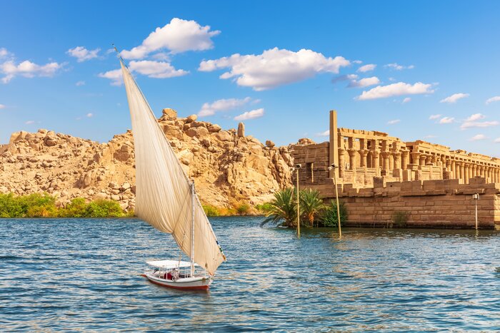 Spot Aswan's landmarks aboard a felucca, a traditional wooden sailboat