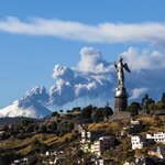 Cotopaxi volcano eruption and Panecillo's Madona seen from Quito, Ecuador