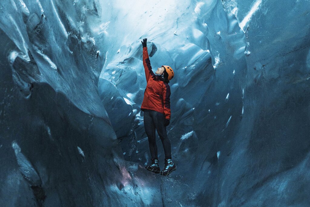 Female explorer in the ice cave