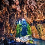 Venture the Tham Lod cave system in northern Thailand by boat or bamboo raft