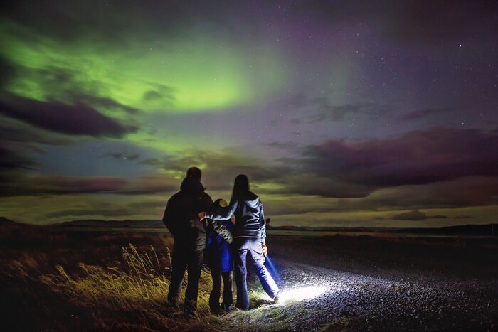 A family watching the northern lights