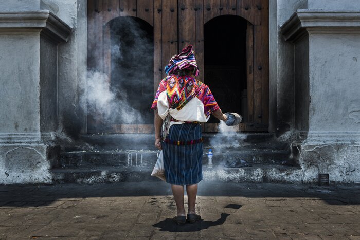 A Maya woman performs a ritual in front of Santo Tomás Church in Chichicastenango