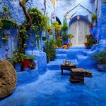  Beautiful shot of a staircase leading to an arched door in Chefchaouen