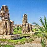 Visit the Colossi of Memnon to see the remnants of Pharaoh Amenhotep III's mortuary temple