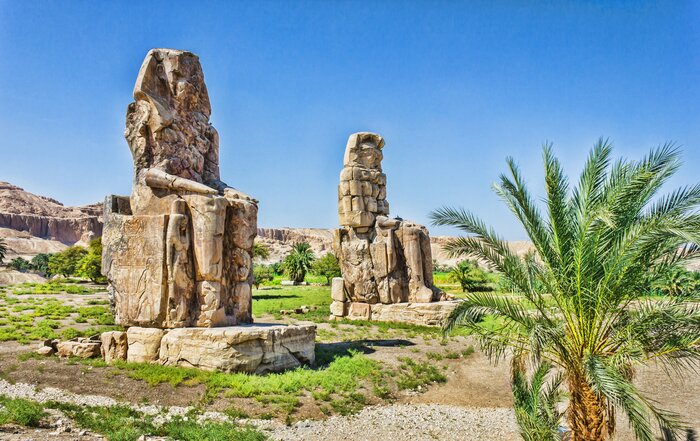 Visit the Colossi of Memnon to see the remnants of Pharaoh Amenhotep III's mortuary temple