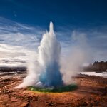 Erupting Strokkur on a sunny day in Iceland