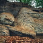 Discover a reclining Buddha among the well-preserved ruins of Polonnaruwa, Sri Lanka's medieval capital