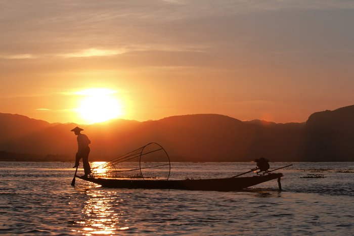 Fisherman silhouette at the sunset on the Inle Lake, Myanmar