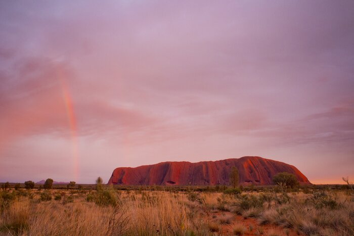 A rainbow over Uluru in Australia's Outback