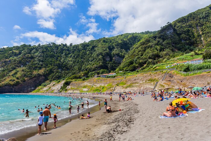 People swimming in the sea and relaxing on nice sandy Praia do Fogo
