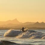Stay two nights in Byron Bay for sunrise beach walks, kayaking, and surfing