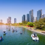Tourists kayak and boat along the river in Incheon's Songdo Central Park