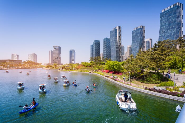 Tourists kayak and boat along the river in Incheon's Songdo Central Park