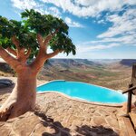 A lodge and its infinity pool overlook Grootberg Canyon