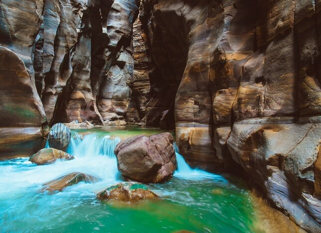 Follow your guide down the Siq Trail in the Mujib Nature Reserve