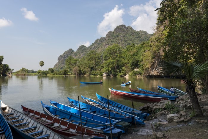   Save Download Preview HPA-AN, MYANMAR - 19 NOVEMBER, 2018: Horizontal picture of the exterior of Sadan Cave and some traditional boats in Hpa-An, Myanmar.